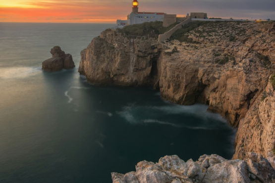 lighthouse-on-a-cliff-overlooking-the-ocean-at-sunset.jpg Lighthouse on a cliff overlooking the ocean at sunset